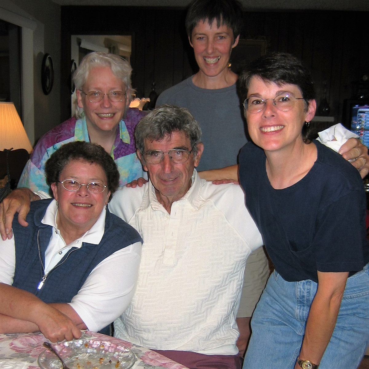 Mom & Dad’s apartment, Olympia Washington. (From L clockwise)  Chris, Carolyn, Dianna, Trish. Dad in middle. (2004)